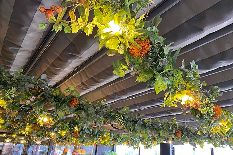case study commercial artificial plant installation of vines, foliage and flowers on bar terrace beams