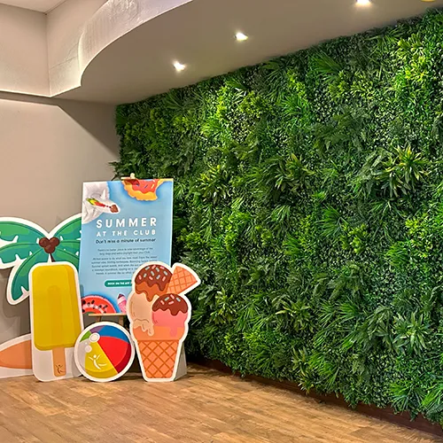 green faux plant wall installations for health club with summer signage