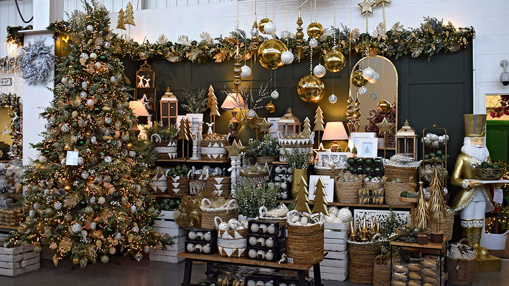 gold and green christmas decorations display with tree and baskets / boxes