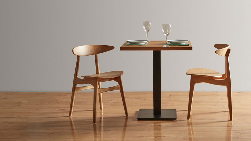 two solid oak contemporary contract chairs and a square contract table with tableware
