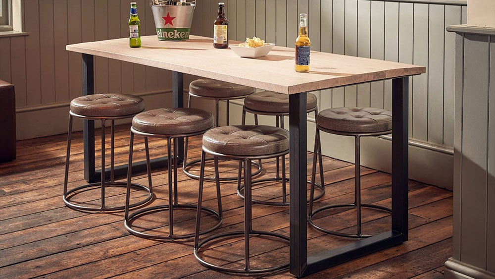 long rectangular contract table with 6 faux leather stools with beer and crisps