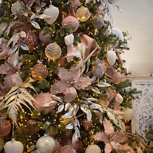 pink christmas decorations - glitter baubles, rose gold leaves and ferns, pink poinsettia
