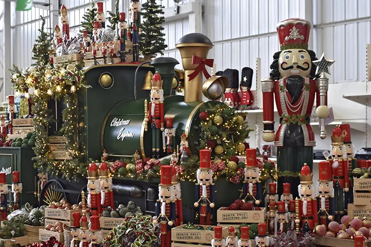 santa's workshop decorations in red gold and green with nutcrackers and display train