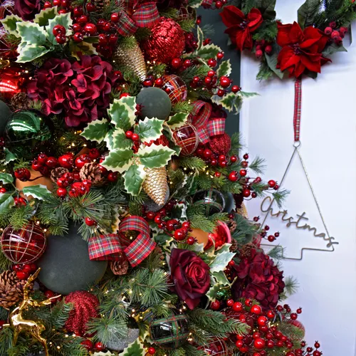 traditional christmas decorations display with red, green, gold and tartan
