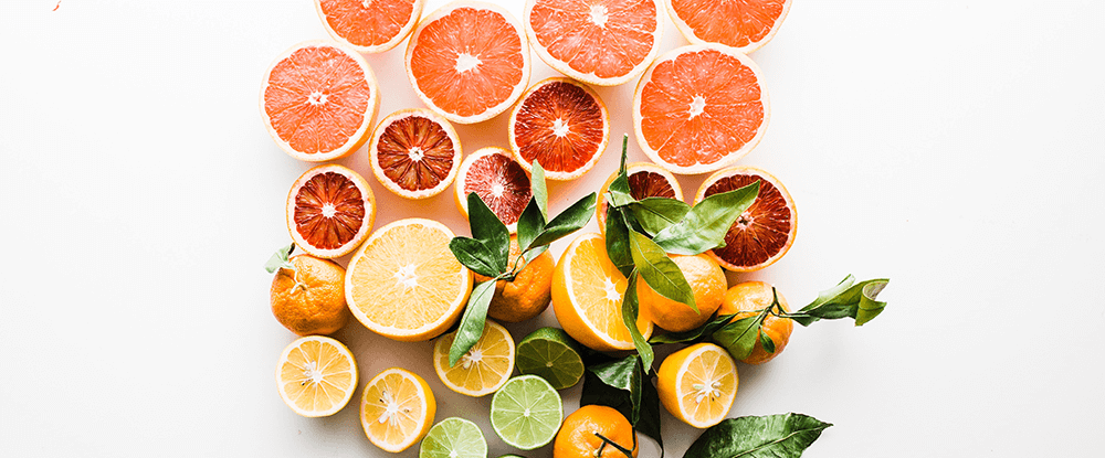 7 summer scents home fragrances - grapefruit, limes and citrus fruits on white background