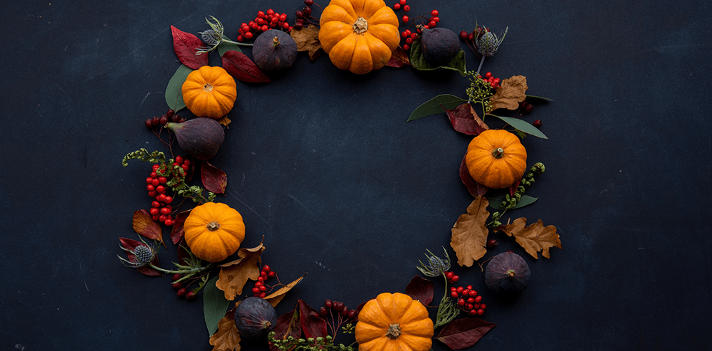 autumnal wreath with small pumpkins leaves figs and berries