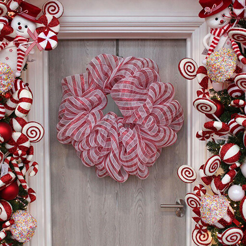 striped red and white candy cane theme material wreath on door