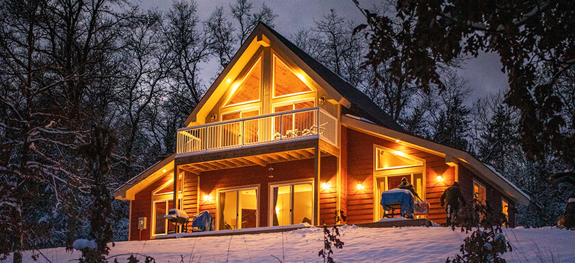 alpine christmas theme inspiration - log cabin at night in snow