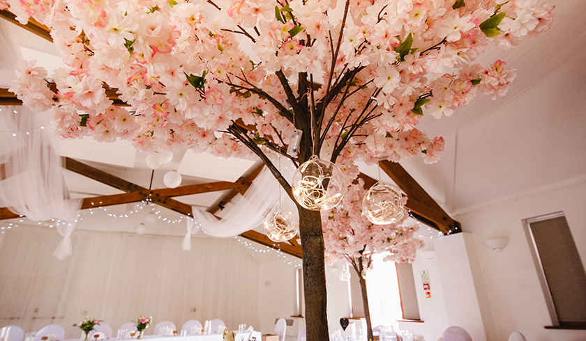 large artificial blossom tree at a wedding with fairylight baubles