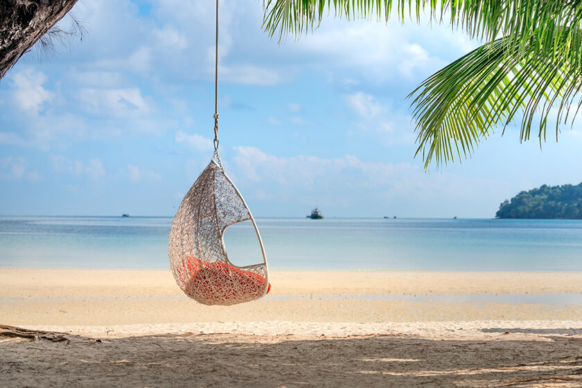 hanging outdoor wicker egg chair on beach