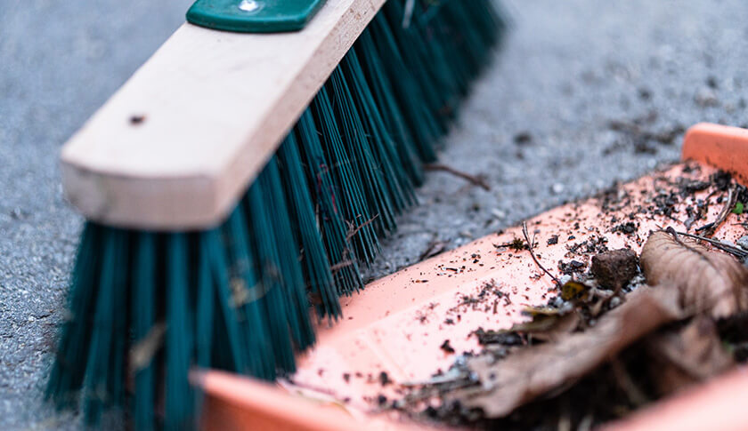 prep for decorating your patio - dustpan and broom