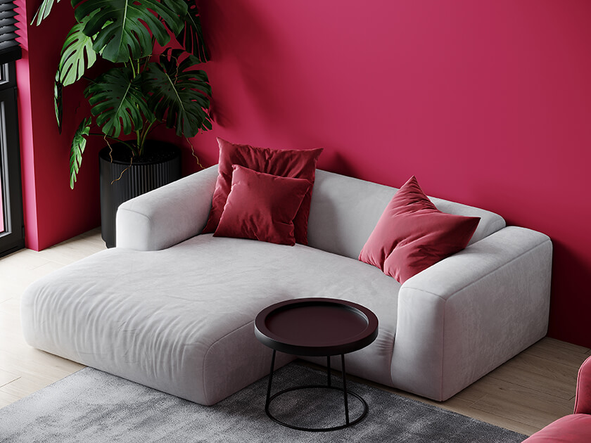 viva magenta wall and cushions with grey sofa - pantone colour of the year 2023