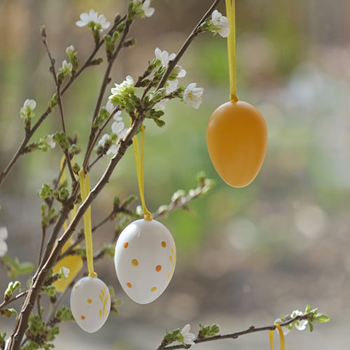 easter tree - hanging egg decorations on a blossom tree outside
