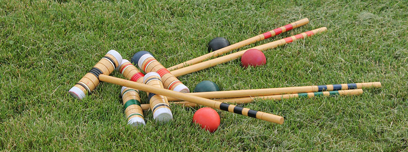 croquet bats and balls on grass - coronation party entertainment