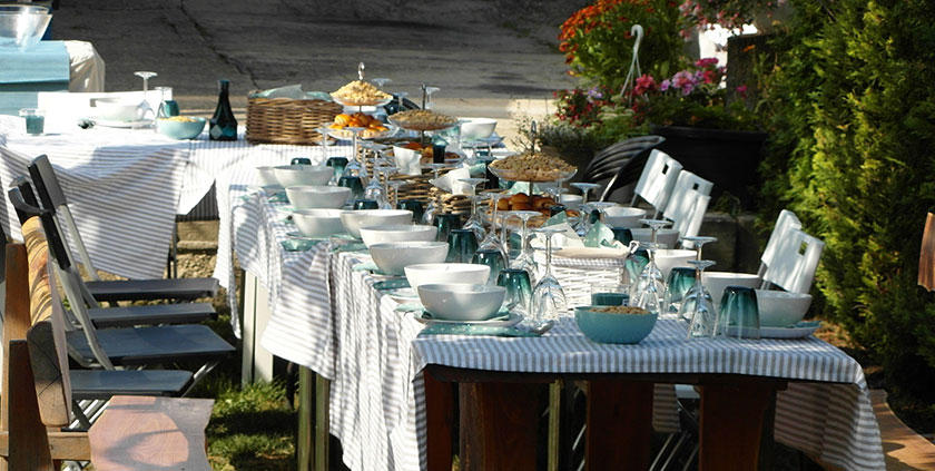 long table outside with food and tableware -coronation party