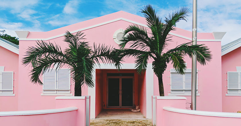 pink house exterior with palm trees