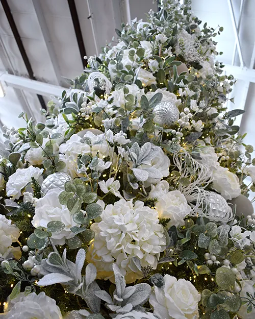 first frostt theme using flowers to decorate a christmas tree to look full