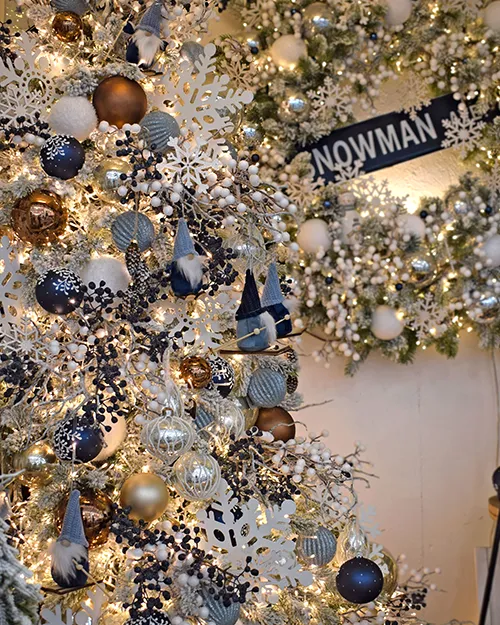 ski lodge theme -n decorate a christmas tree to look full using blue berries