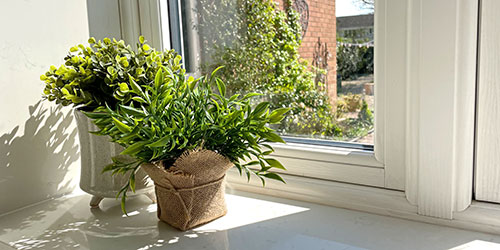 Artificial Plants - green faux plant in pot on kitchen surface