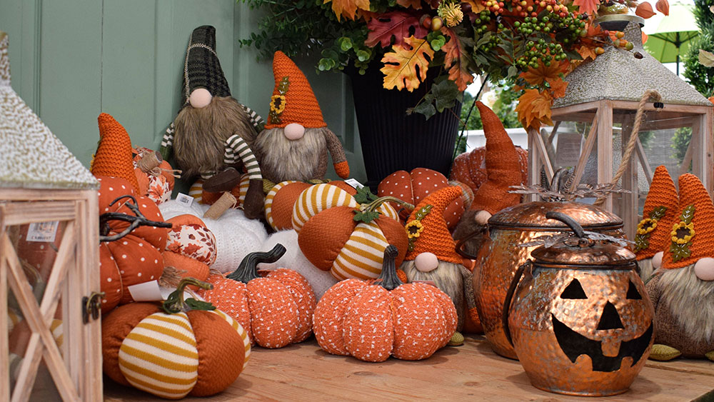 collection of autumn decorations - knitted pumpkins, lanterns, gonks and foliage