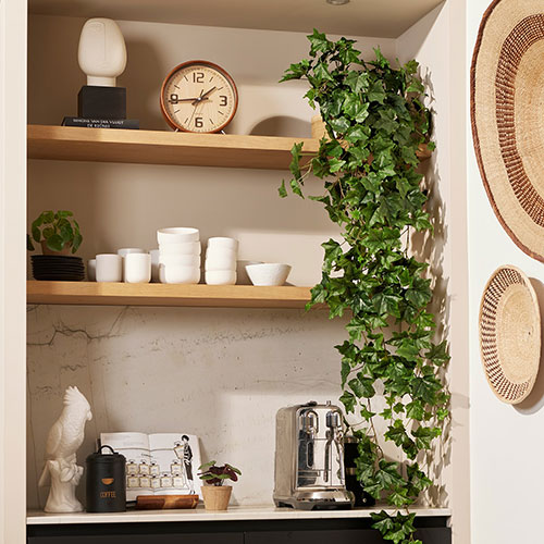 artificial ivy trailing from a high shelf