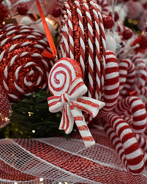 red and white swirl lollipop with bow decoration on ribbon