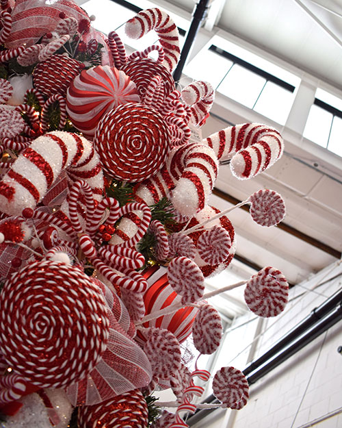 candy cane shaped christmas decorations in red and white striped tinsel and lollipop decorations