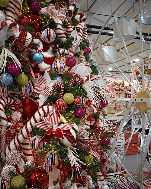 fun carnival themed christmas decorations on large tree and ferris wheel display