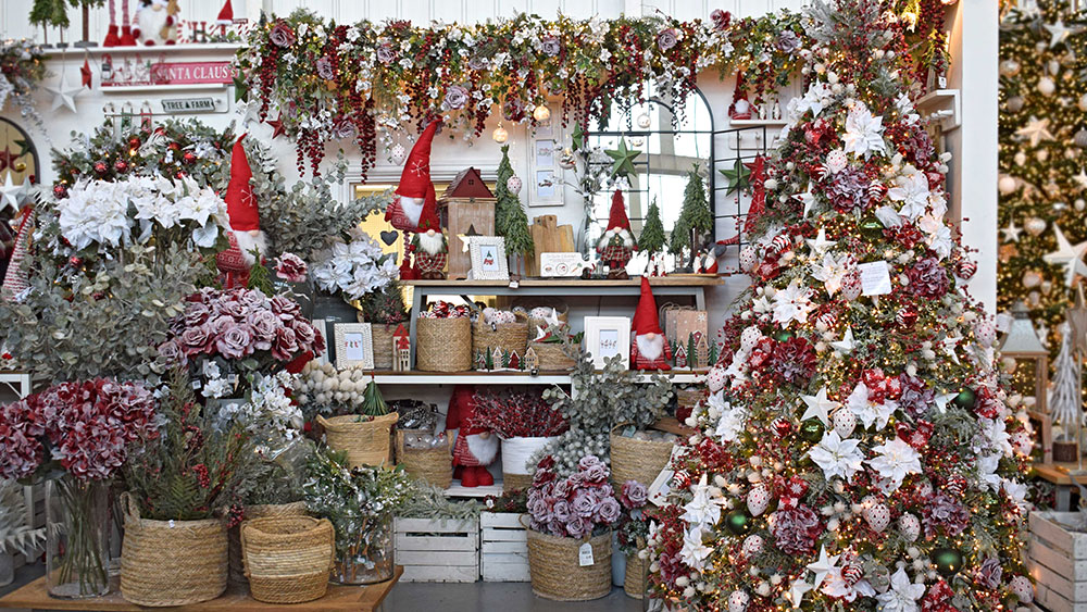 classic Christmas decorations display in red, white, and green with frsoted foliage and flowers