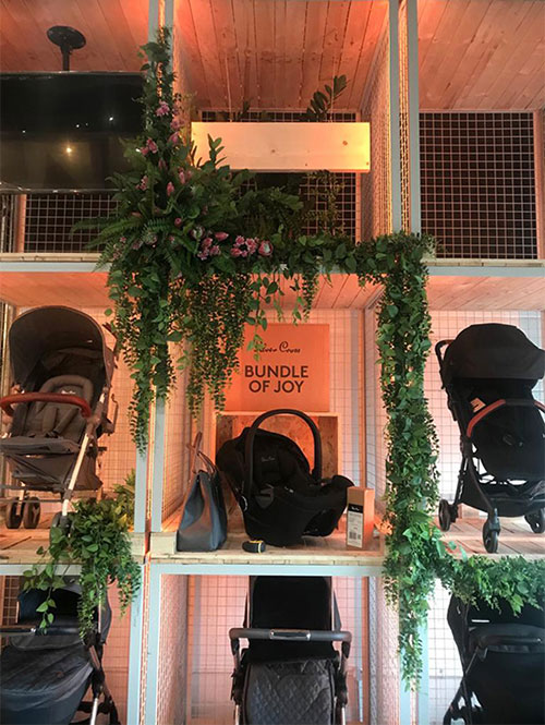 industrial retail display unit cubes with prams and faux vines foliage