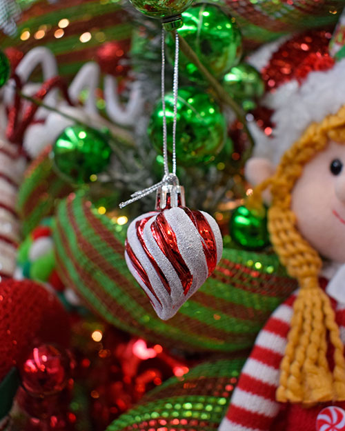 close up of red and white striped heart bauble