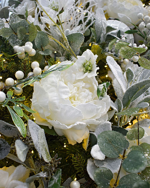 close up of frosty white artificial peony, frosted eucalyptus and faux white berries
