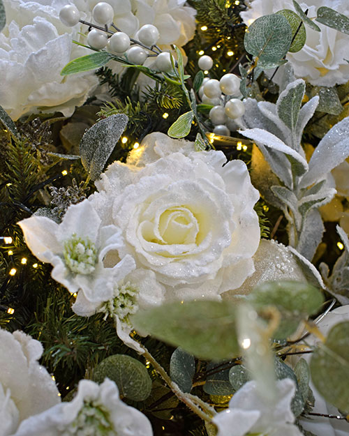 frosted white faux rose, lambs ear foliage, hellebore spray, white berries in christmas tree with lights
