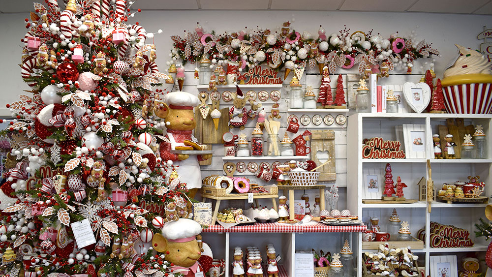 gingerbread christmas theme display with tree, standing chef mice ornaments and lots of baked goods decorations