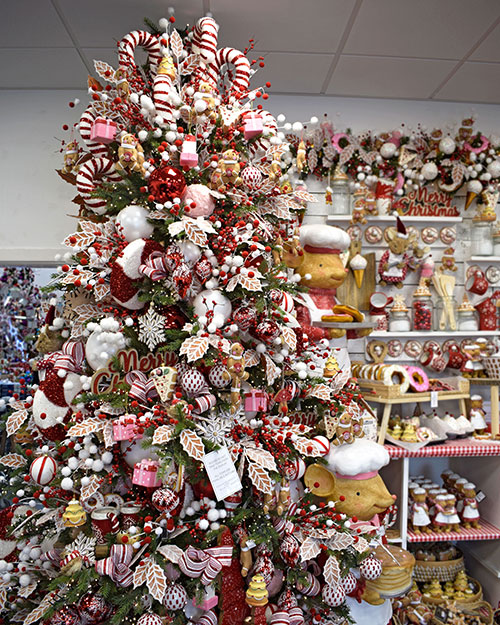 red, white, and brown gingerbread christmas tree theme and display in background