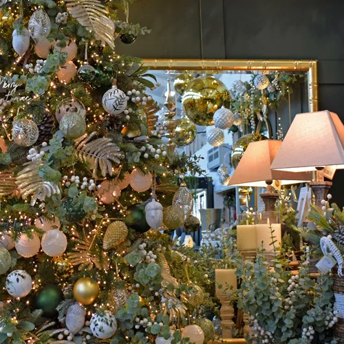 gold and green christmas decorations display with tree