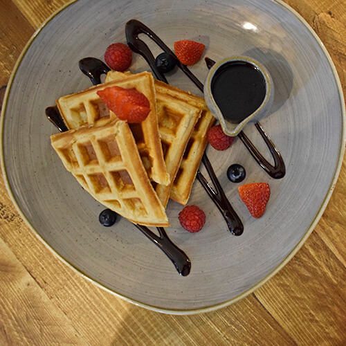 waffles, strawberries, chocolate sauce on plate