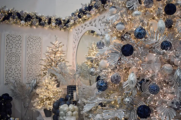 midnight blue christmas decorations with silver on a tree with mirrored wall