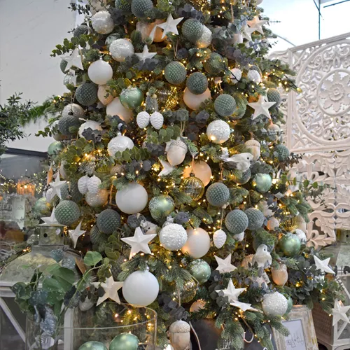 white berries and textured green christmas decorations on tree