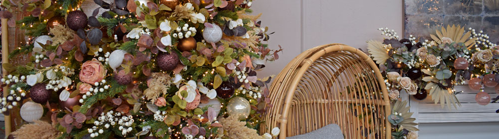 mocha neutral theme christmas decorations - wicker chair, faux dried flowers, pampas grass, white berries, and baubles