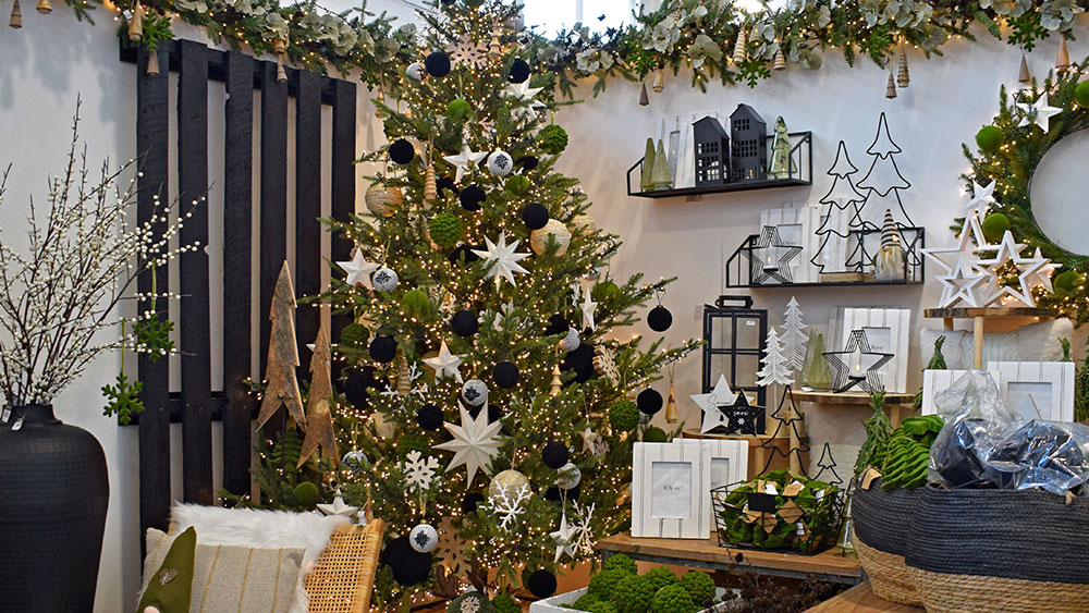 nordic theme christmas decorations - black baubles, white stars, green felt snowflakes, with wooden ornaments and baskets
