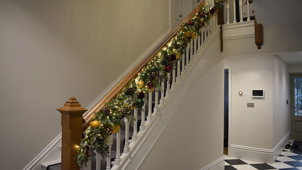 residential christmas decorating service north wales - garland around wooden banister