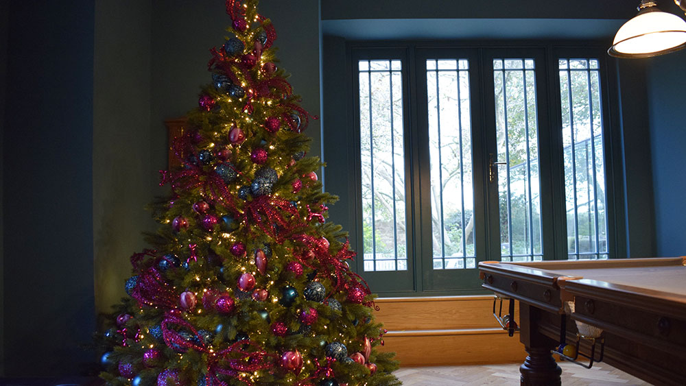 dark blue pool table room with pink and teal christmas tree