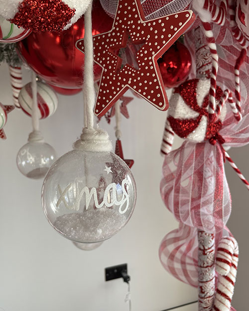 residential christmas decorating service - candy cane red and white decorations baubles stars close up