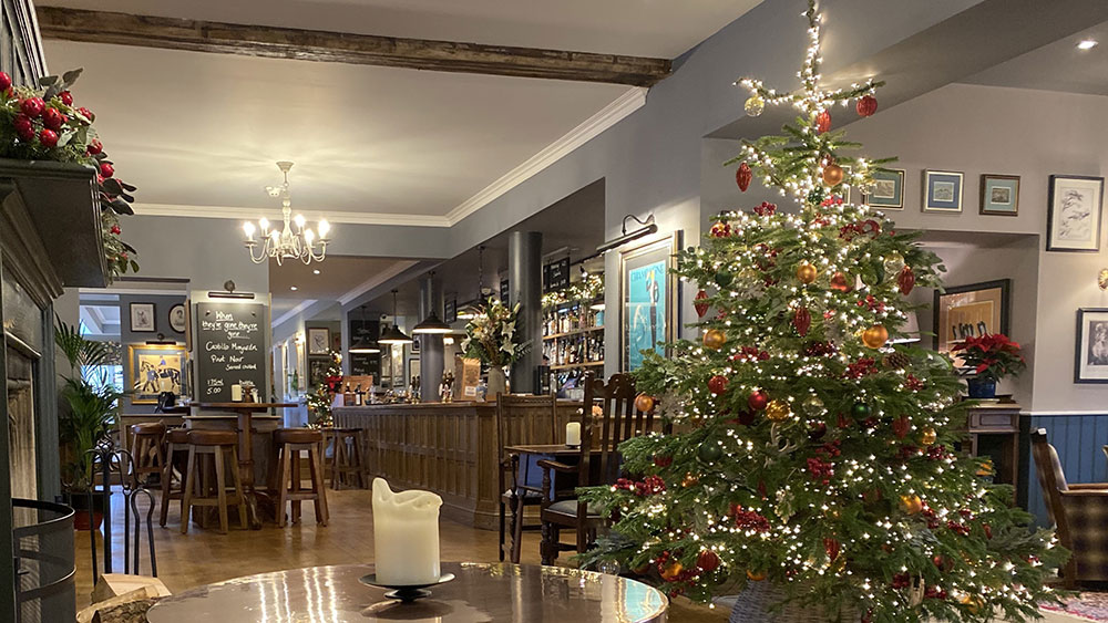 rake hall pub restaurant christmas decorating service - Christmas tree near bar with fairy lights