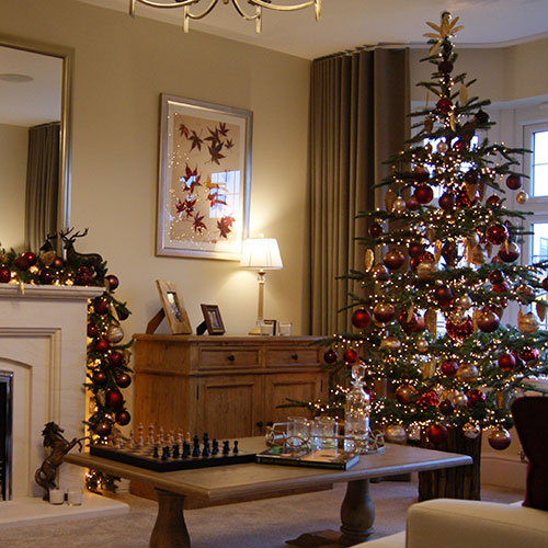traditional red and gold christmas decorations in show home living room