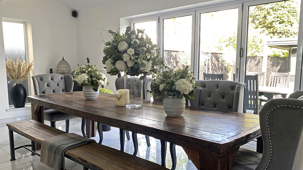 three white rose and hydrangea bespoke artificial floral arrangements on dining table