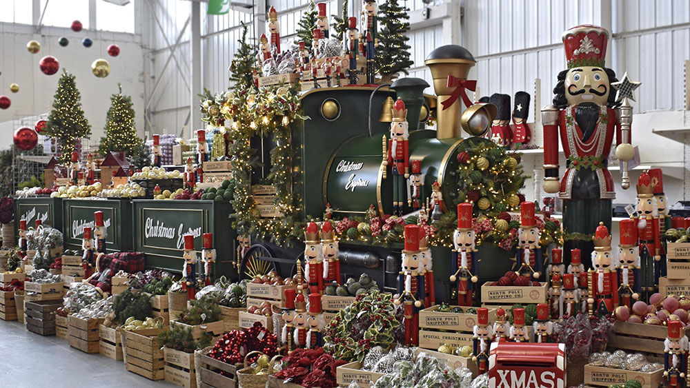 santa's workshop decorations in red, gold, and green with large green display train and nutcracker figures