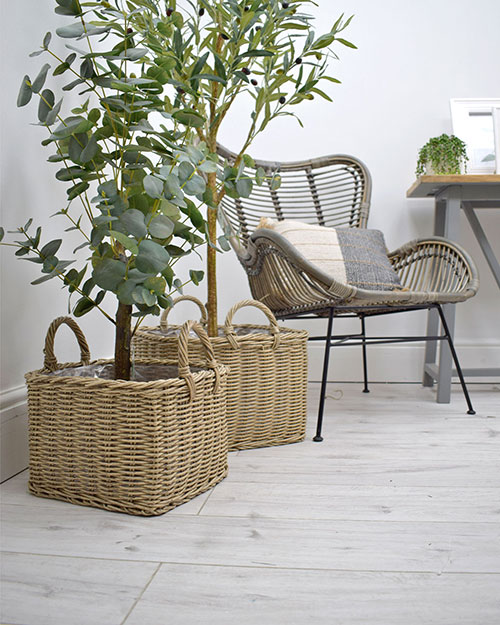 two beige poly rattan rectangular baskets used as planters