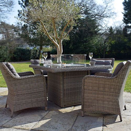 grey square outdoor rattan dining table for 4 people with fire pit and wine glasses